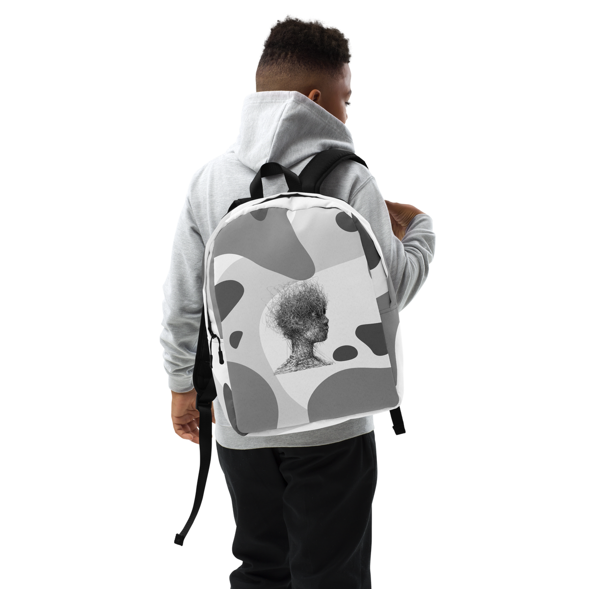 Grey and white camo backpack worn by model with adjustable straps