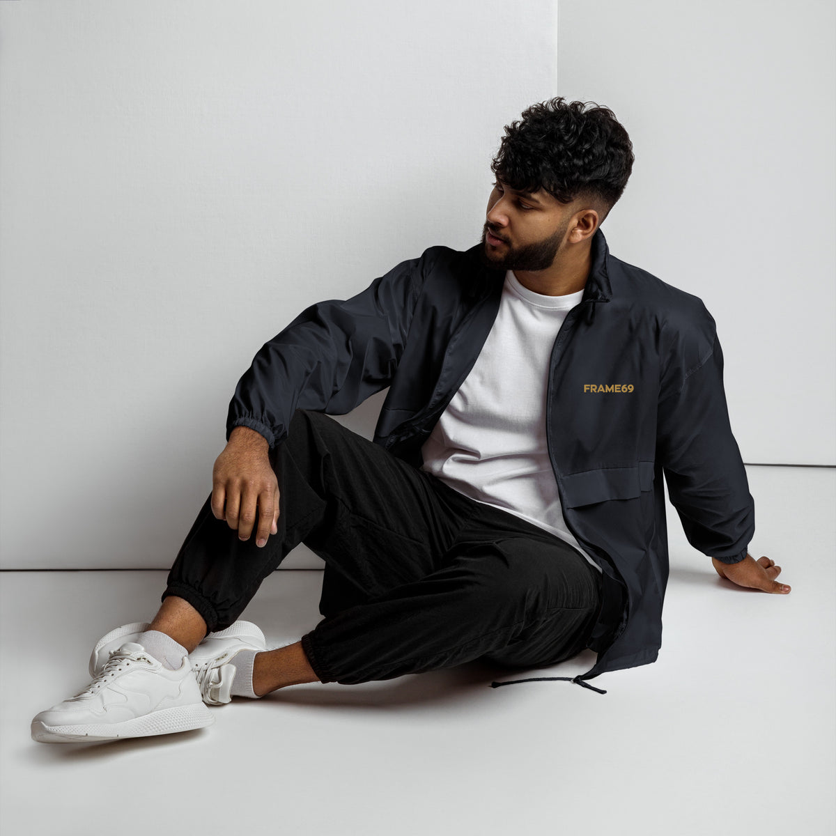Black windbreaker jacket, zip front, chest logo and side pockets