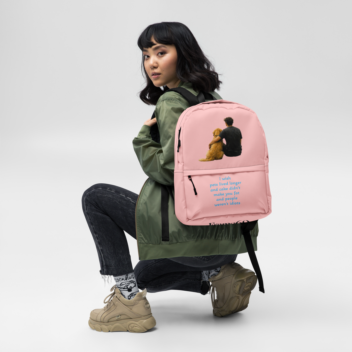 Pink everyday backpack with front graphic of a person holding a yellow teddy bear