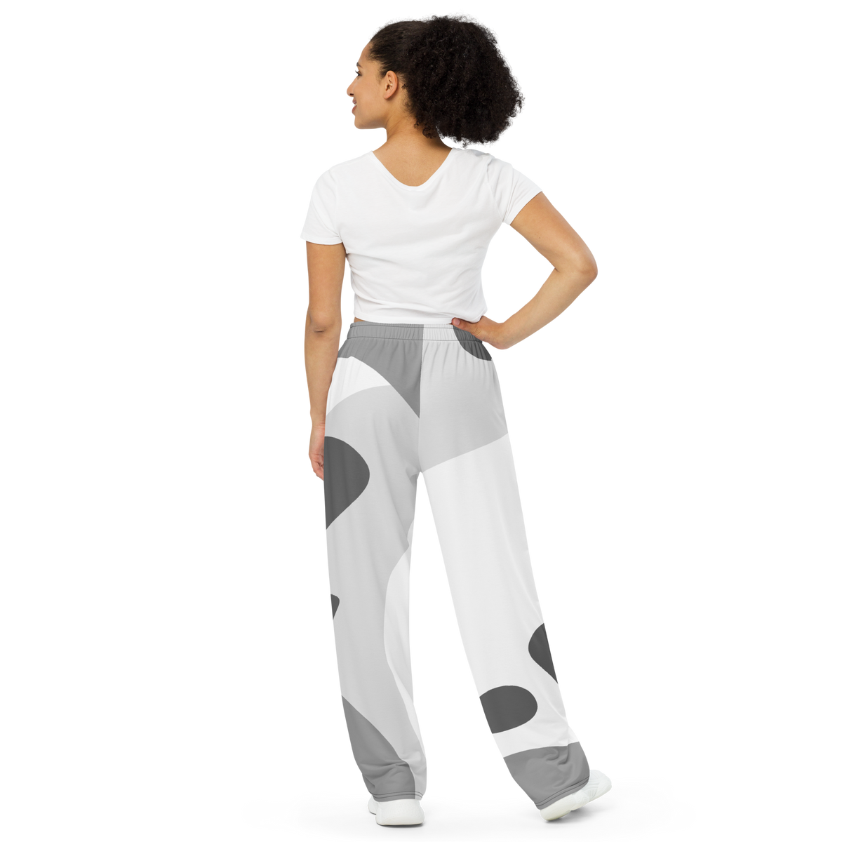 White wide-leg lounge pants with gray abstract print and elastic waistband, full length.