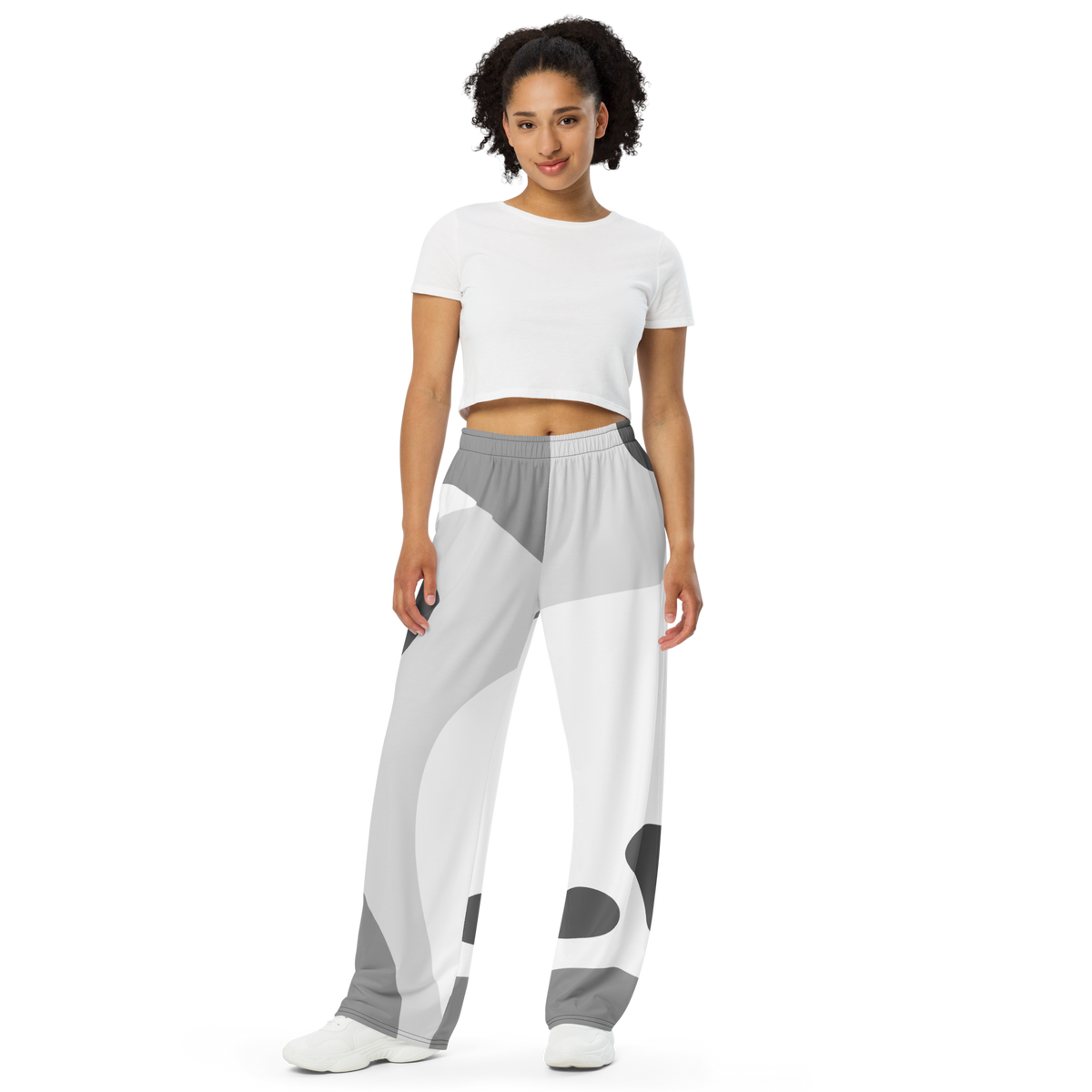 White wide-leg lounge pants with abstract gray and dark shapes, elastic waistband.
