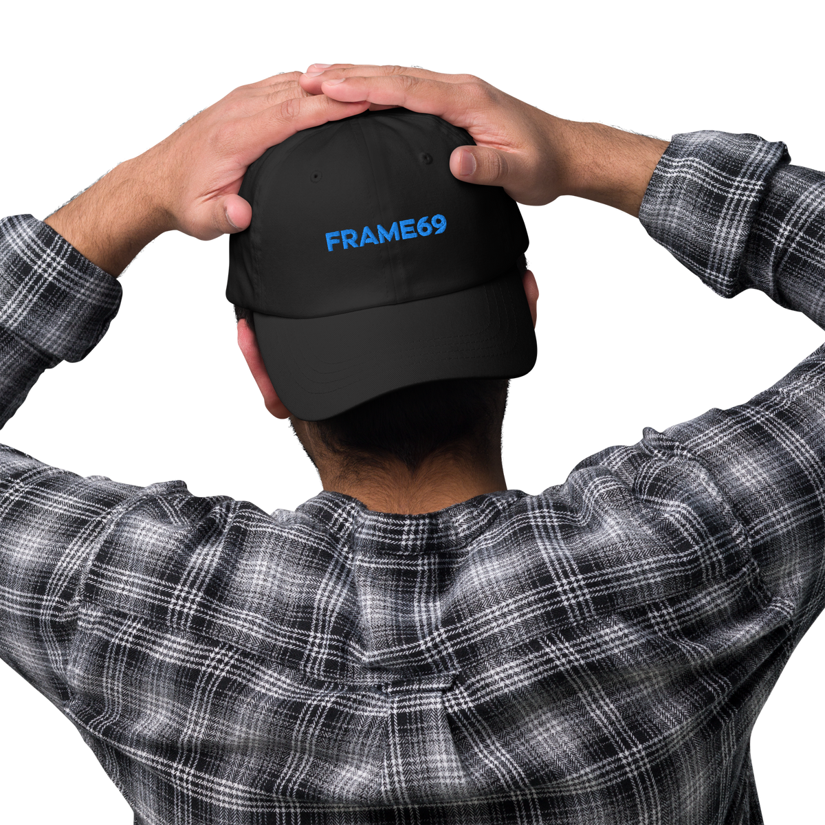 Black chino dad hat with FRAME69 logo, being adjusted