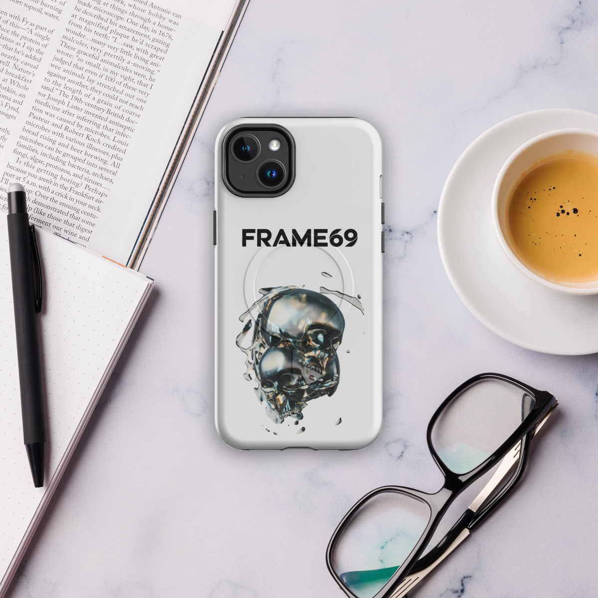Light gray MagSafe phone case with skull art and FRAME69 logo, camera cutouts