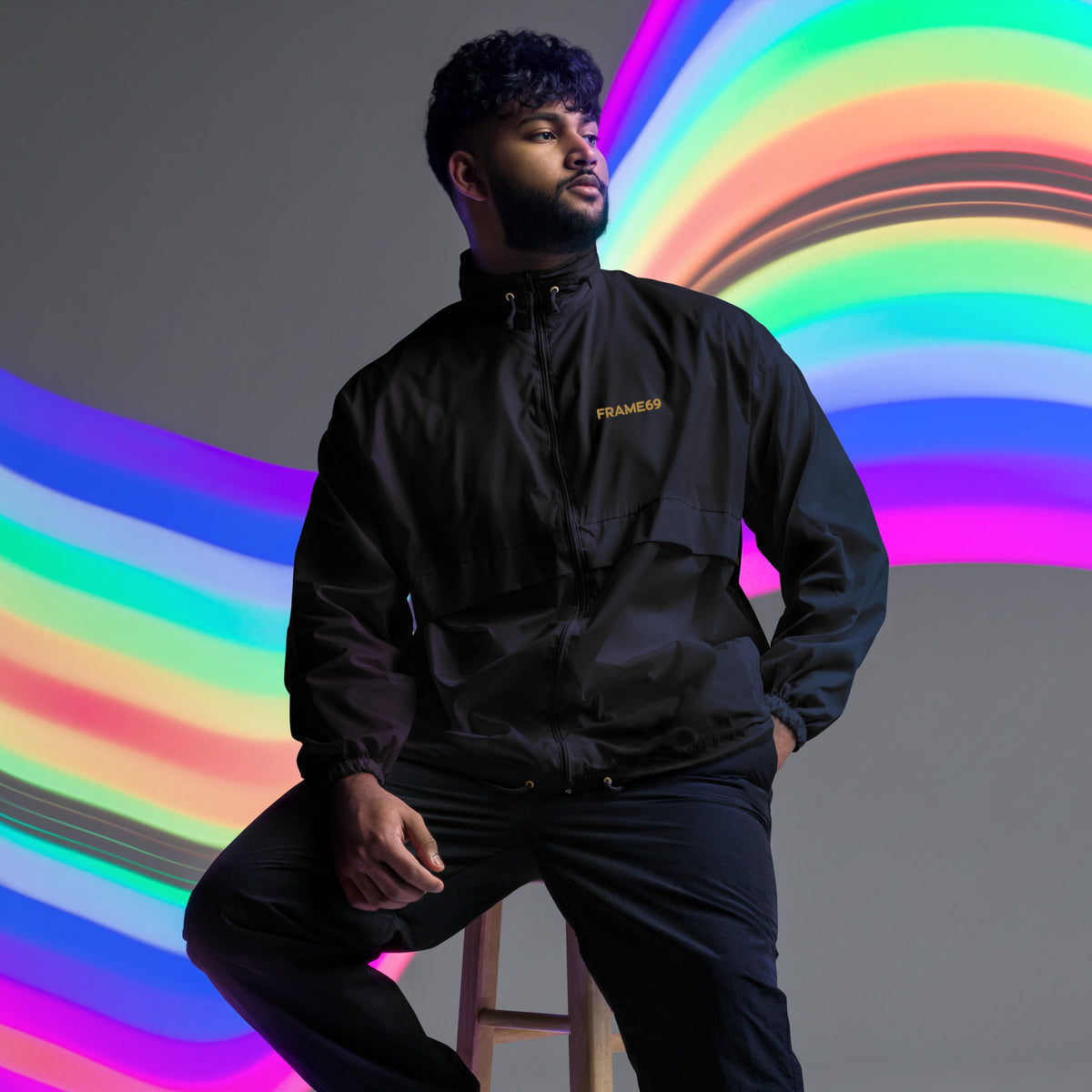 Black windbreaker jacket with FRAME69 logo on chest, full outfit view
