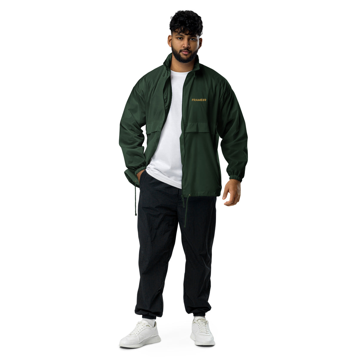 Forest green windbreaker jacket with hood, full-zip front, and FRAME69 logo worn open