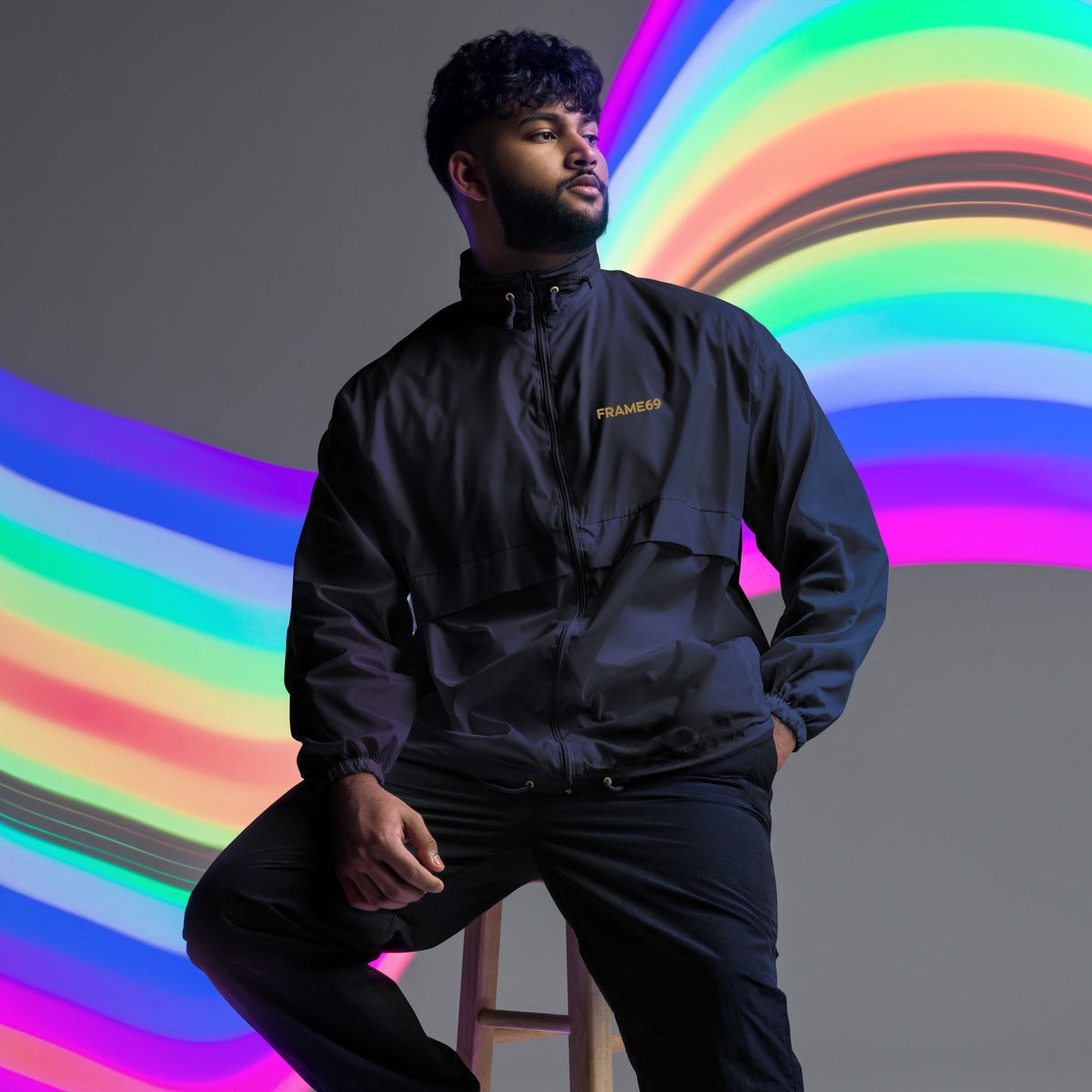 Black windbreaker jacket with FRAME69 logo on chest, full outfit view
