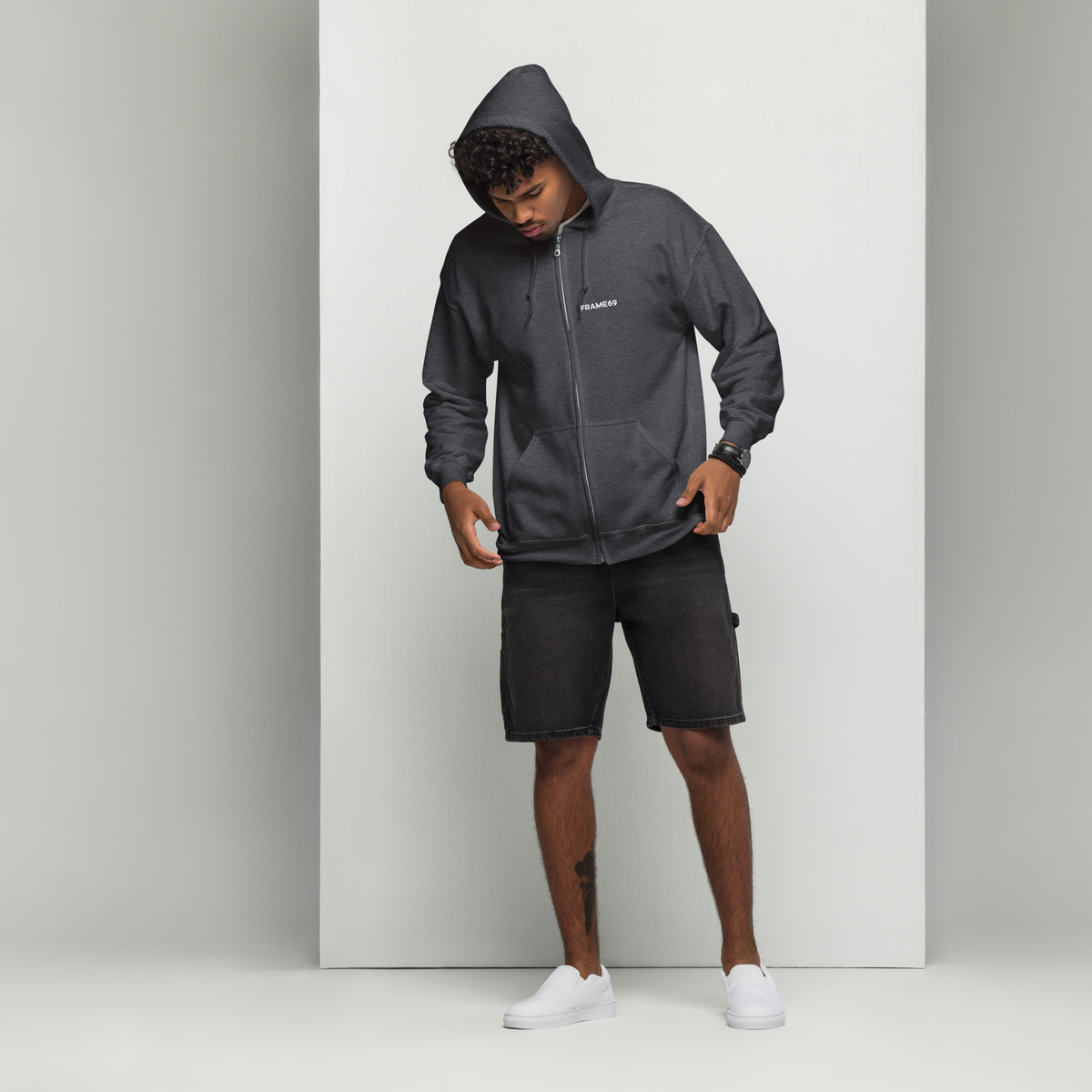Dark heather zip-up hoodie with hood and front zipper; minimal chest logo.