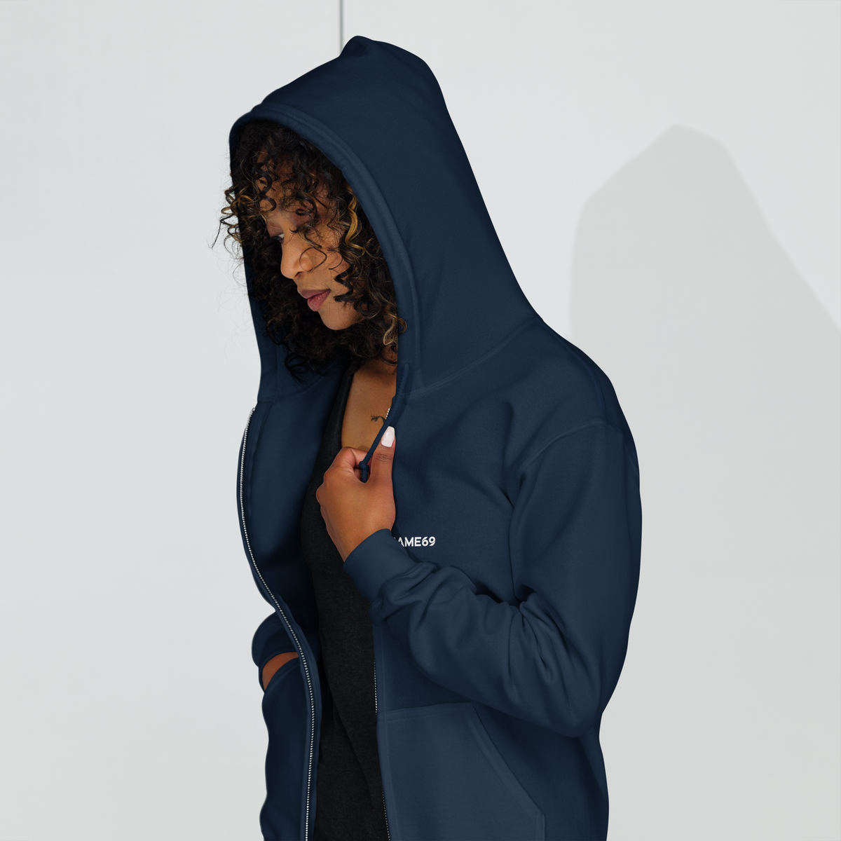 Navy zip-up hoodie with hood and chest logo; zipper partially open.