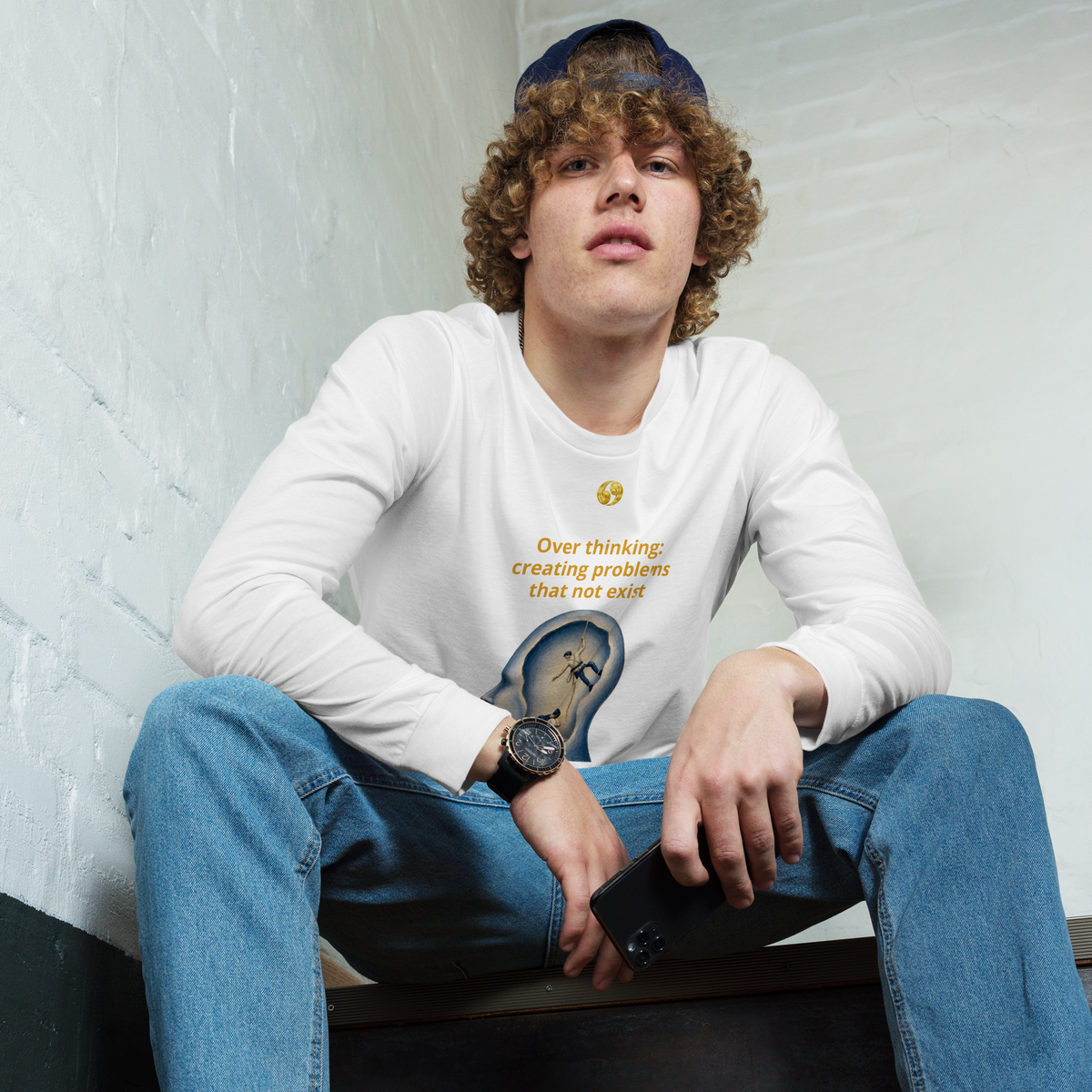 White long-sleeve tee with crew neck and chest graphic emblem