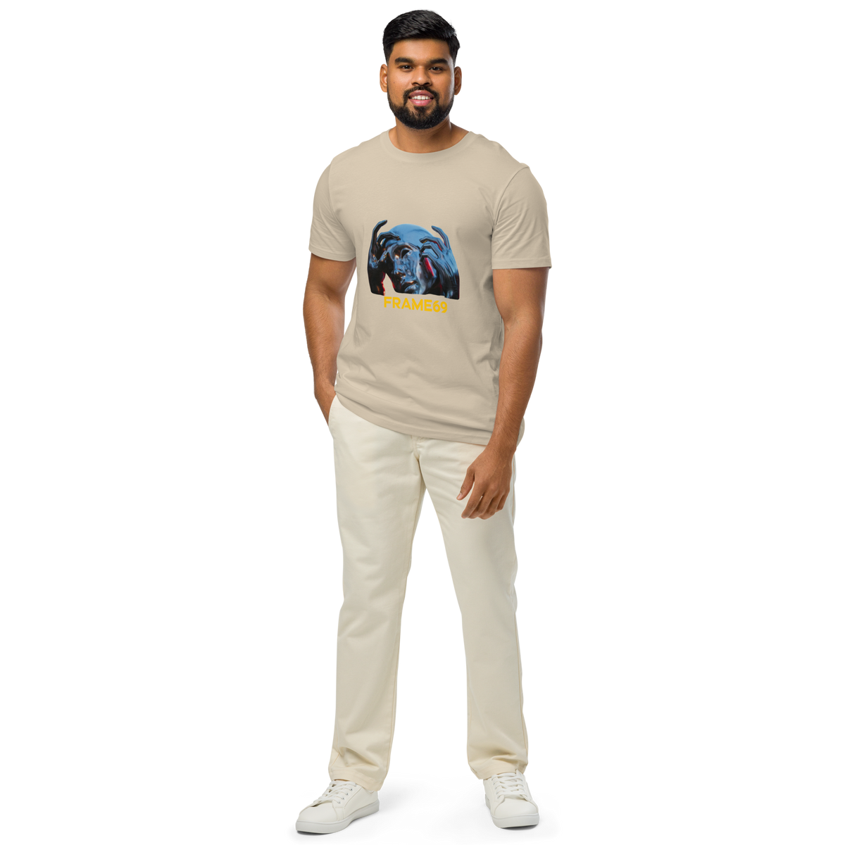 Beige graphic crew-neck T-shirt with colorful face print and “FRAME69” text, worn