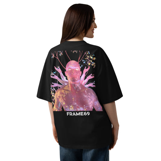 Black oversized organic cotton tee with vivid pink figure artwork and FRAME69 logo on back