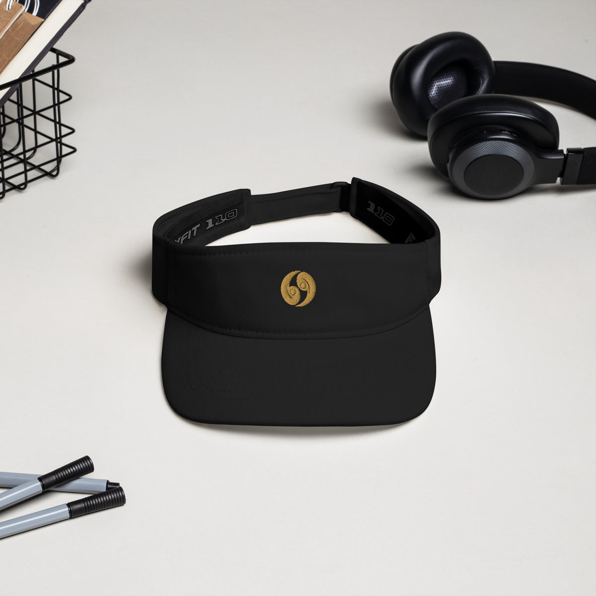 Black classic visor with curved brim and gold logo, adjustable strap and inner band