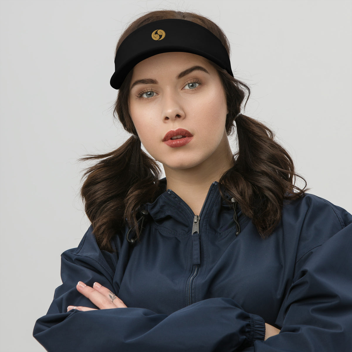 Black classic visor with curved brim and gold logo, adjustable rear band