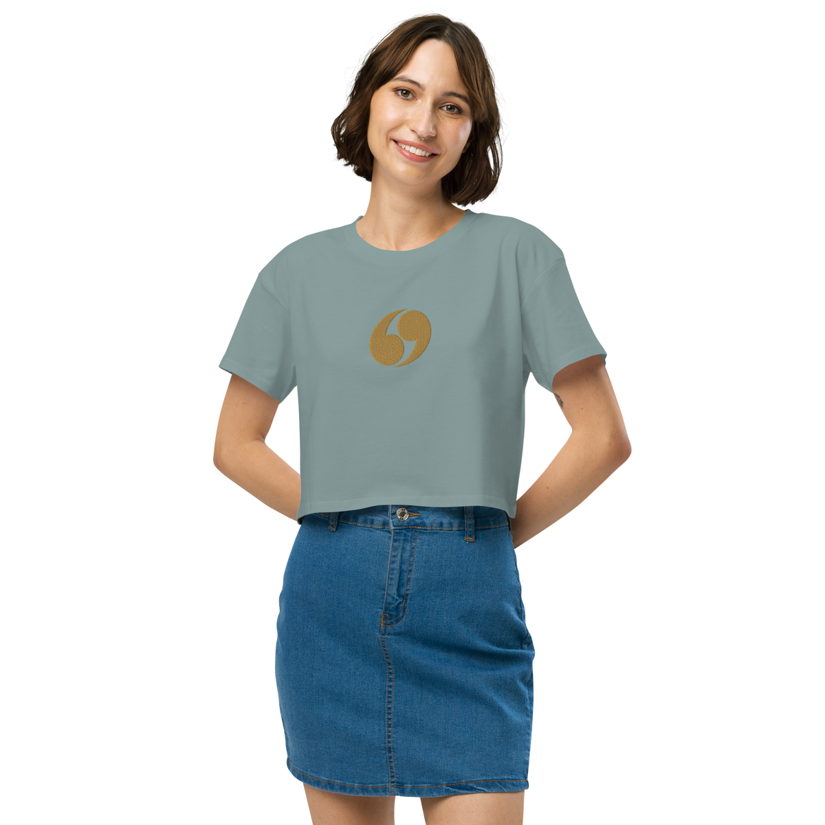 Dusty blue cropped T-shirt with crew neck and small gold logo at center chest