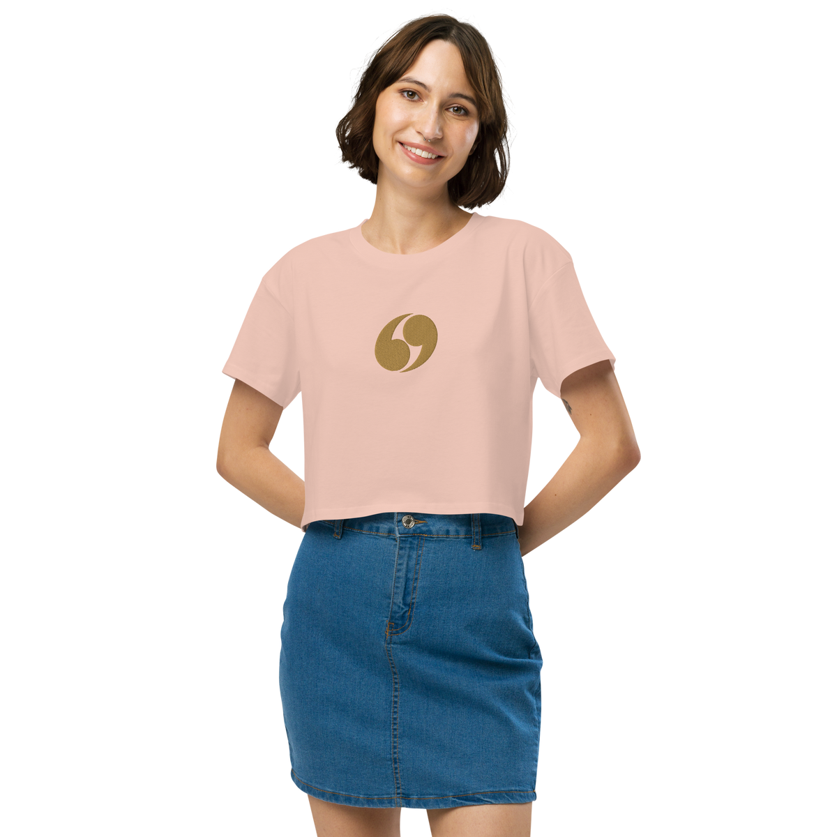 Light pink cropped T-shirt with crew neck and small gold logo at center chest