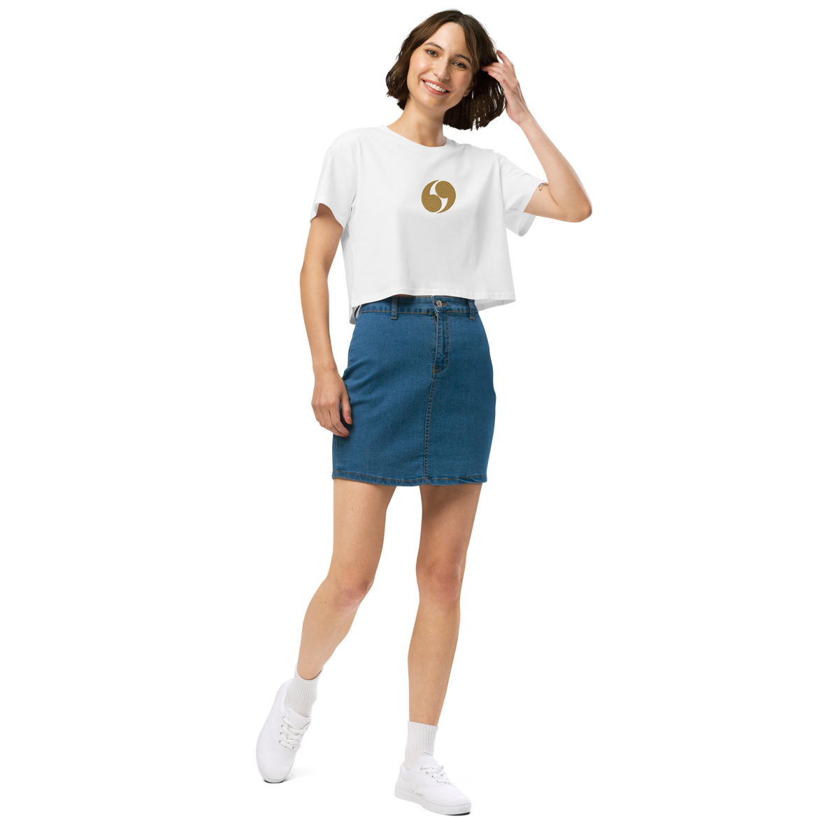White cropped tee with short sleeves and small gold logo patch